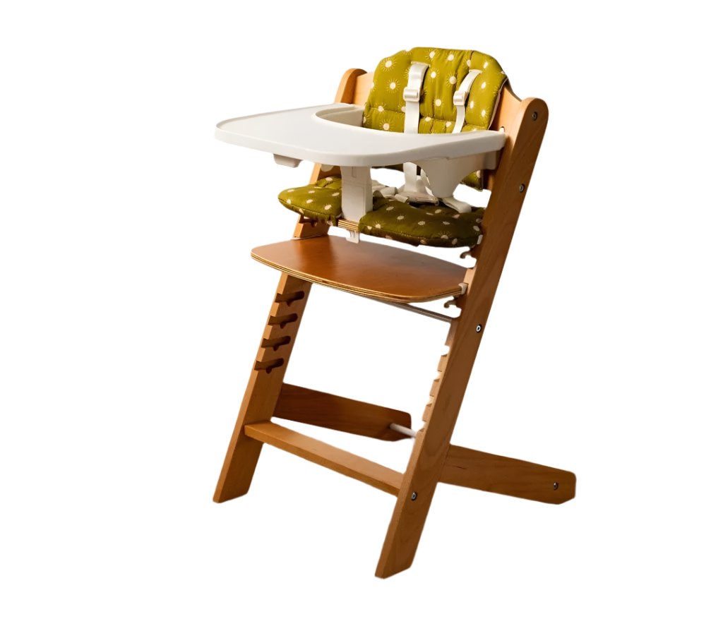 Wooden high chair with green cushion on a wooden floor