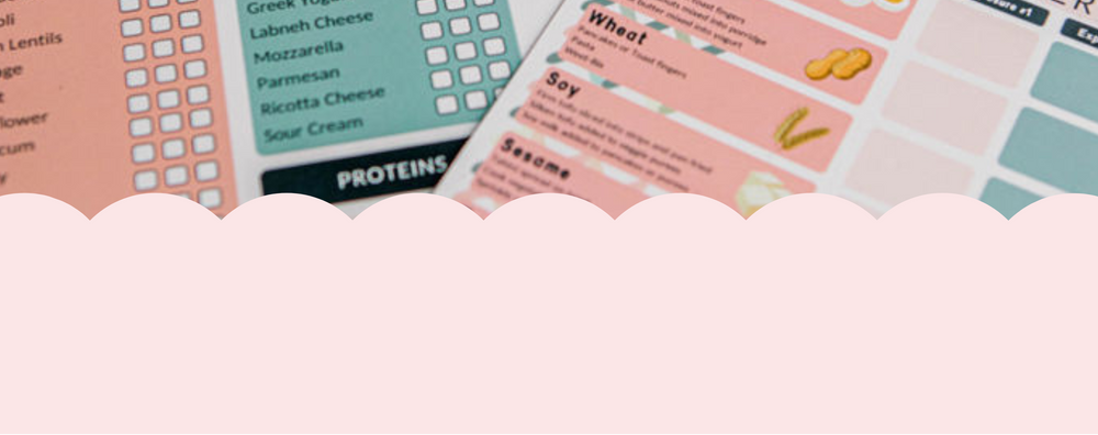 Set of food allergy and meal planner sheets on a marble surface