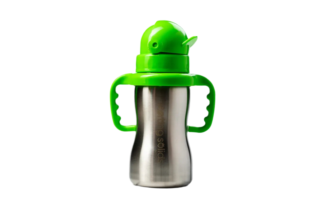 Stainless steel sippy cup with green handle and lid on a marble background