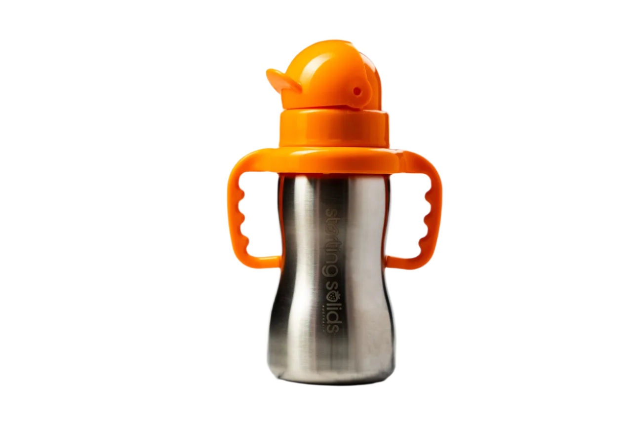 Silver sippy cup with orange handle and lid on a marble background