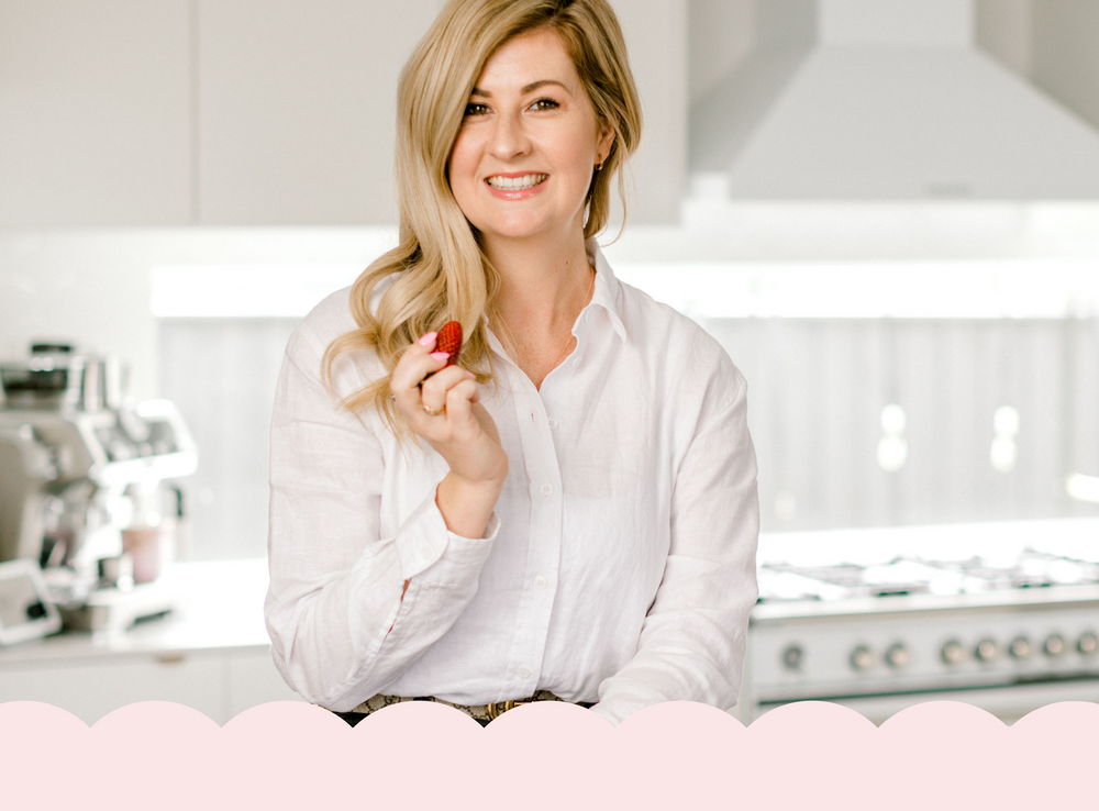 Woman holding a red object in a kitchen setting