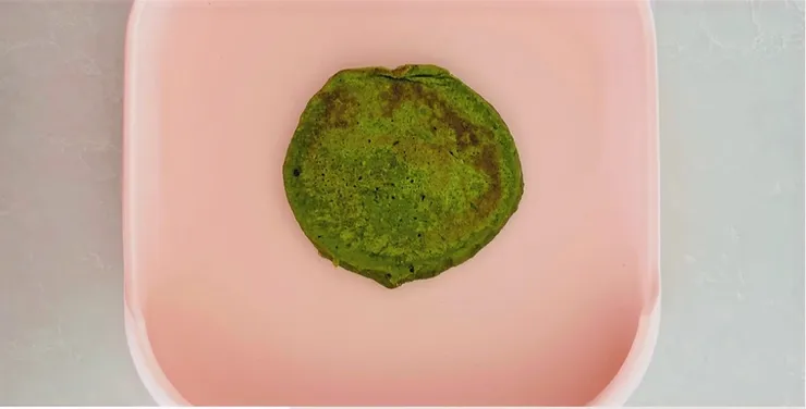 Green pancakes on pink silcione plate - Starting Solids Australia recipe.
