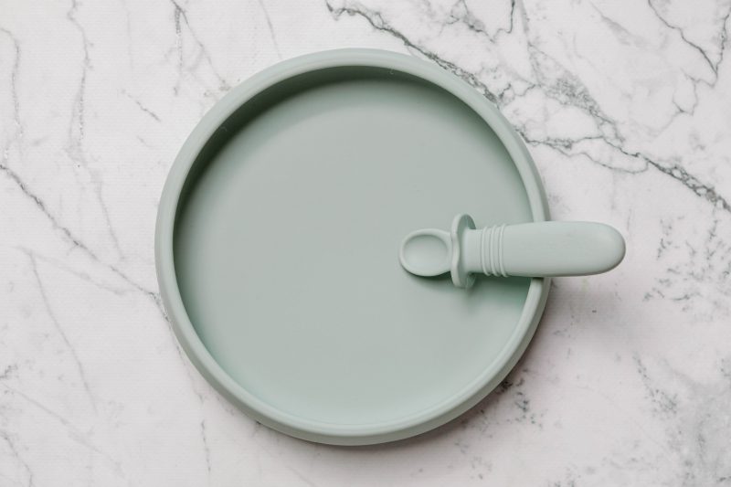 Suckie Scoop Plate with Selfie Spoon by Starting Solids Australia, on a marble bench.