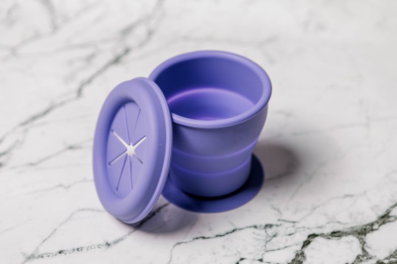 Purple silicone Snackie Cup for babies by Starting Solids Australia on a marble bench.