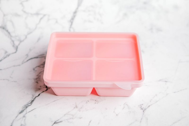 'Fairy Floss' pink Freezie Tray for baby food storage by Starting Solids Australia on a marble bench.