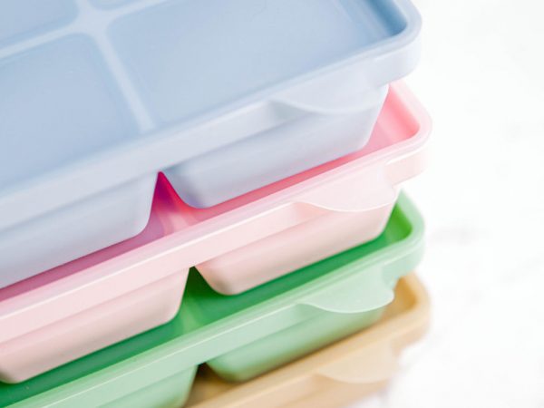 Stack of coloured Freezie Trays by Starting Solids Australia on a marble bench.
