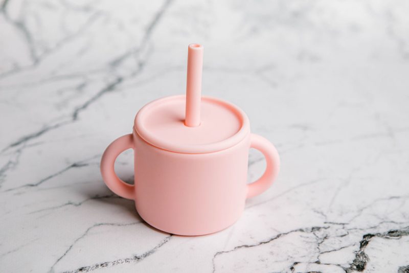 Ideal First Baby Cup in 'Fairy Floss' pink by Starting Solids Australia, on marble bench.