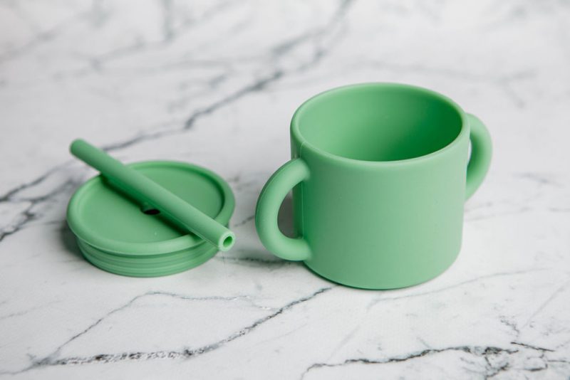 Ideal First Baby Cup in 'Mint Crisp' green by Starting Solids Australia, in parts, on a marble bench.