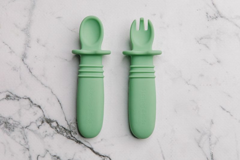 Green Silicone baby cutlery on a marble bench by Starting Solids Australia