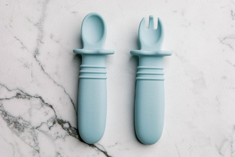 Blue silicone baby cutlery on a marble bench by Starting Solids Australia