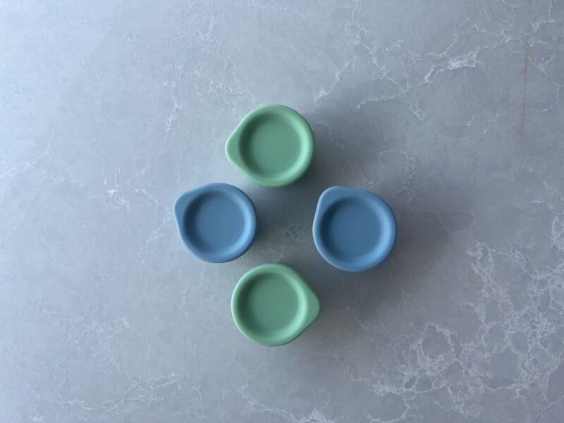 Birdseye view of blue and green Tiny Tiny containers on a bench by Starting Solids Australia