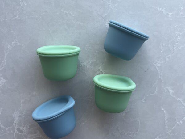 Four Tiny Tiny containers in blue and green colours by Starting Solids Australia