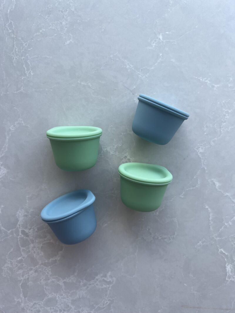 Four Tiny Tiny containers in blue and green colours by Starting Solids Australia