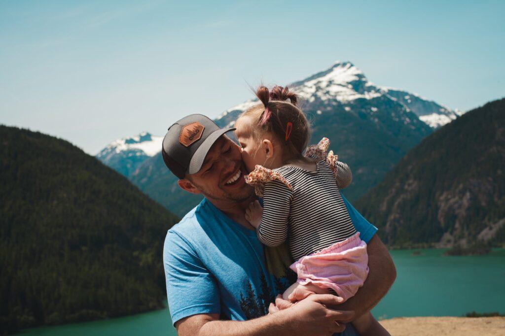 travel food ideas for babies man carrying her daughter smiling