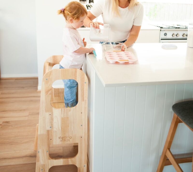 Toddler in kitchen using Starting Solids Australia's Toddler Tower